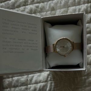 Skagen Denmark watch. Gold band. Mother of pearl face stones for each hour